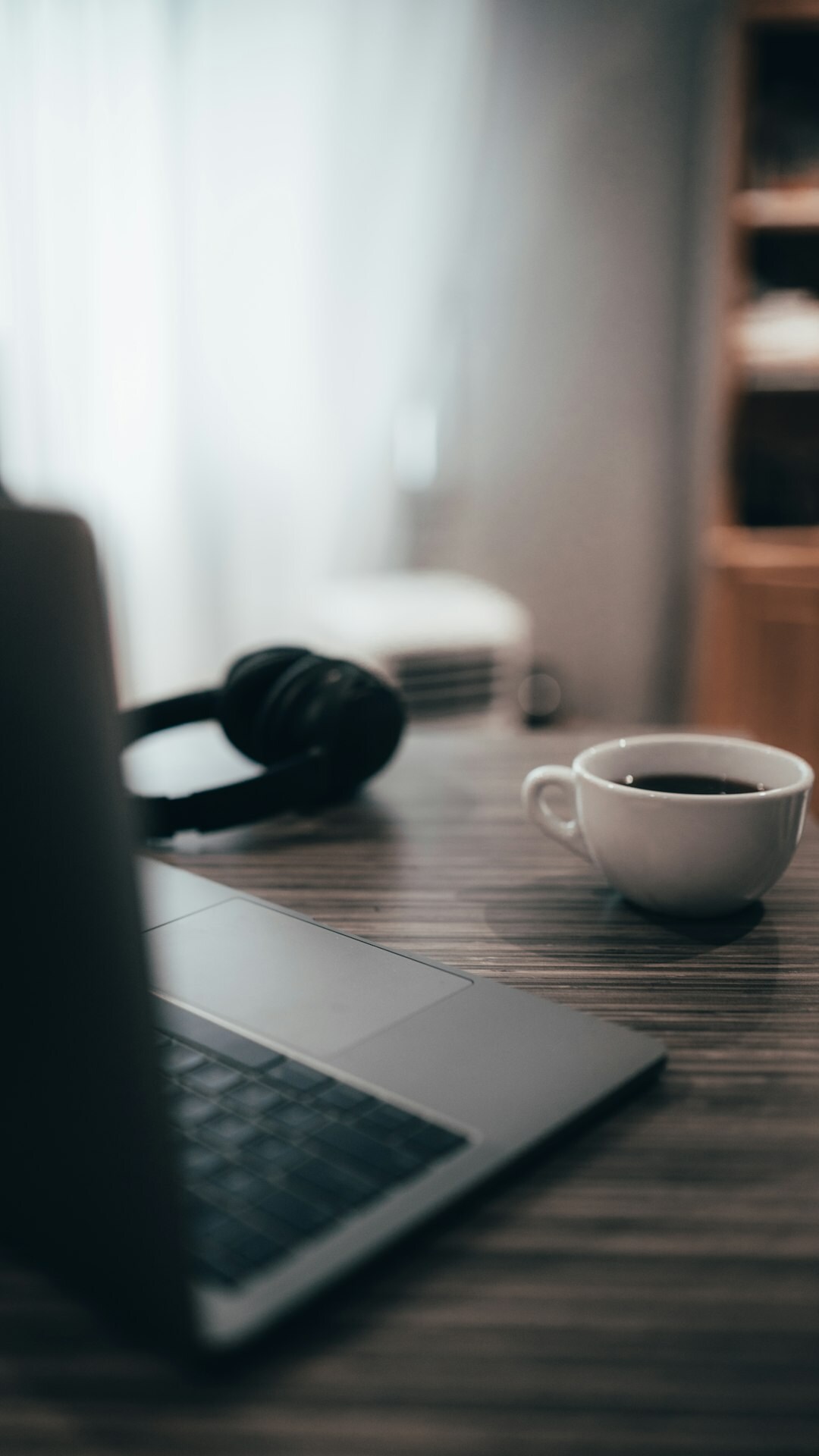 Desk with laptop, notebook and coffee cup used for planning a broadcast training session